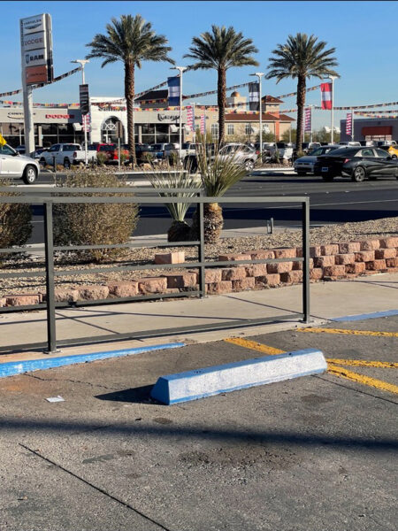 iron handrails for a sidewalk near a parking lot