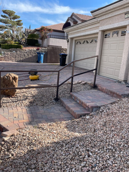 handrails for paved steps leading up to a garage and driveway