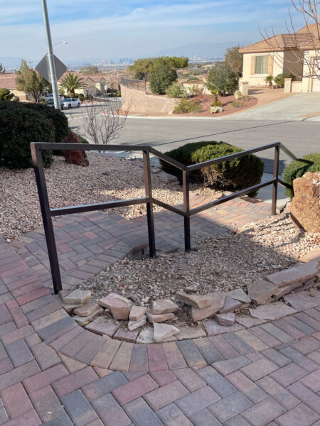 handrails for a paved residential driveway